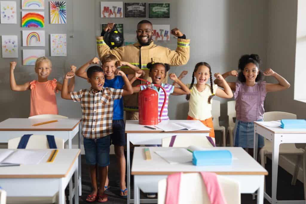 Firefighter with children in classroom, fire safety education, school safety program, fire drill training, child safety awareness.