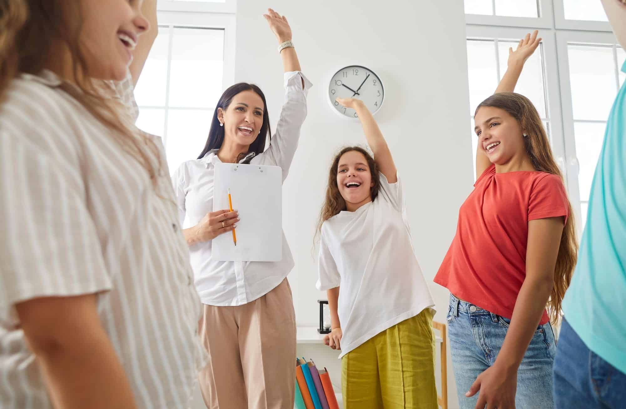 Inspiring children raising hands in classroom for educational behavior support and personalized learning.