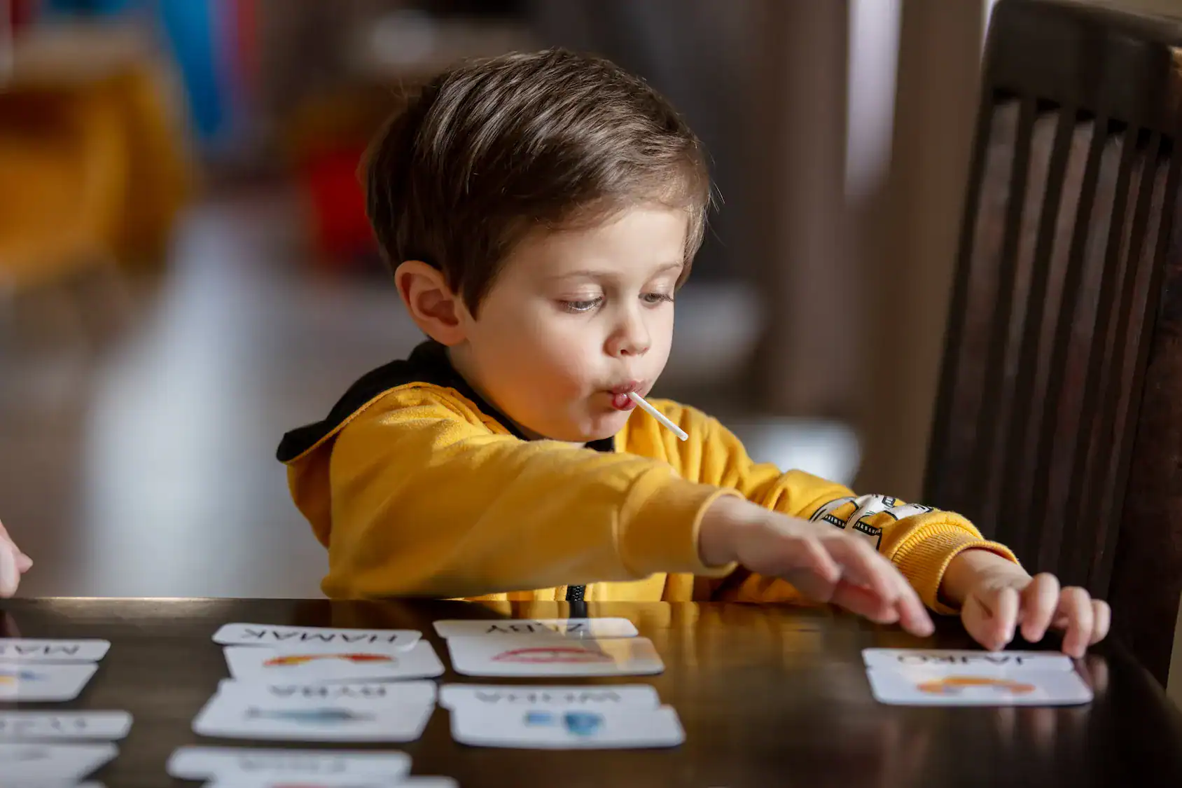 Child engaging with flashcards to develop language, reading, and educational behavior skills.