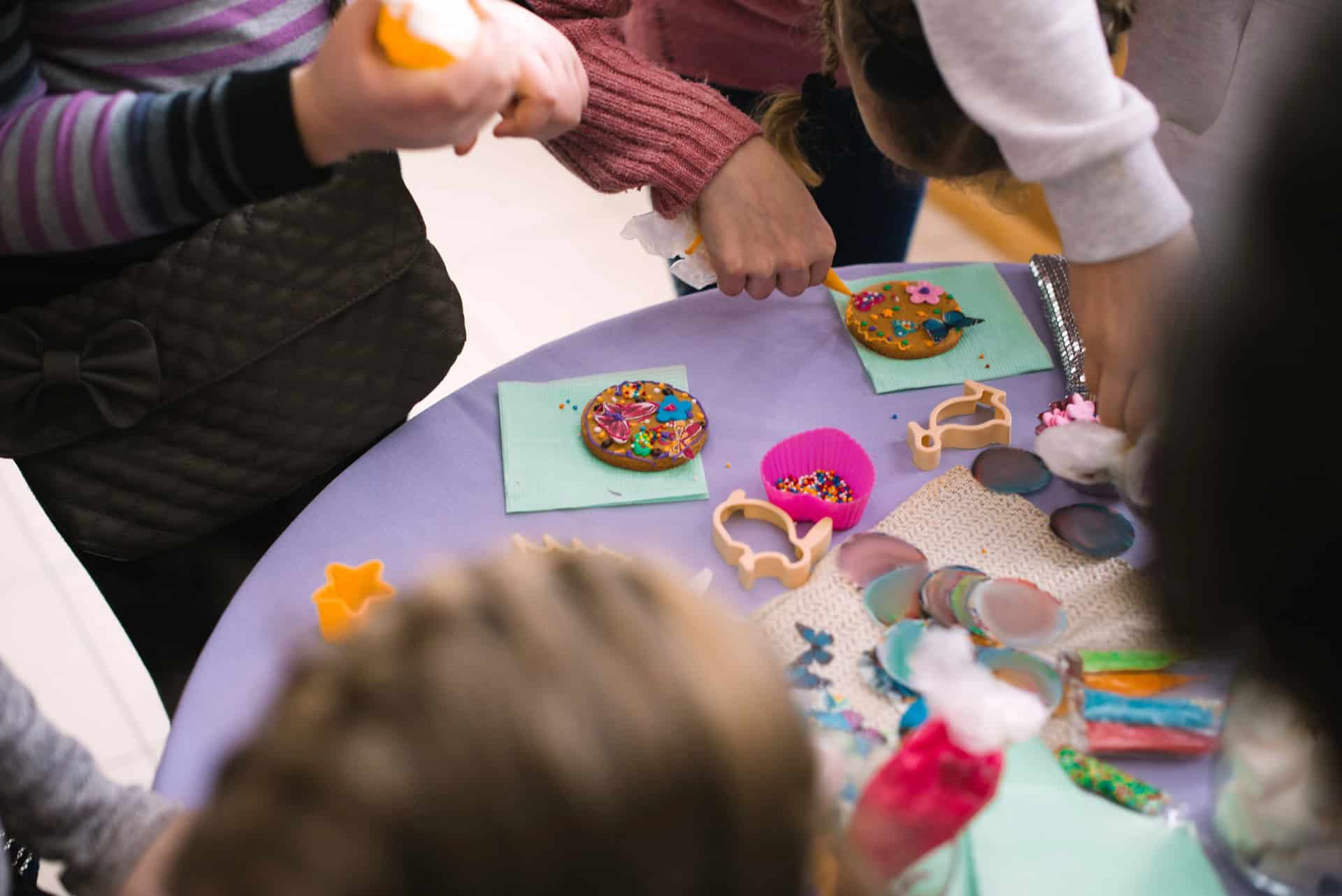 Colorful decorated cookies and craft supplies for children's activities, promoting educational enrichment and behavior development.