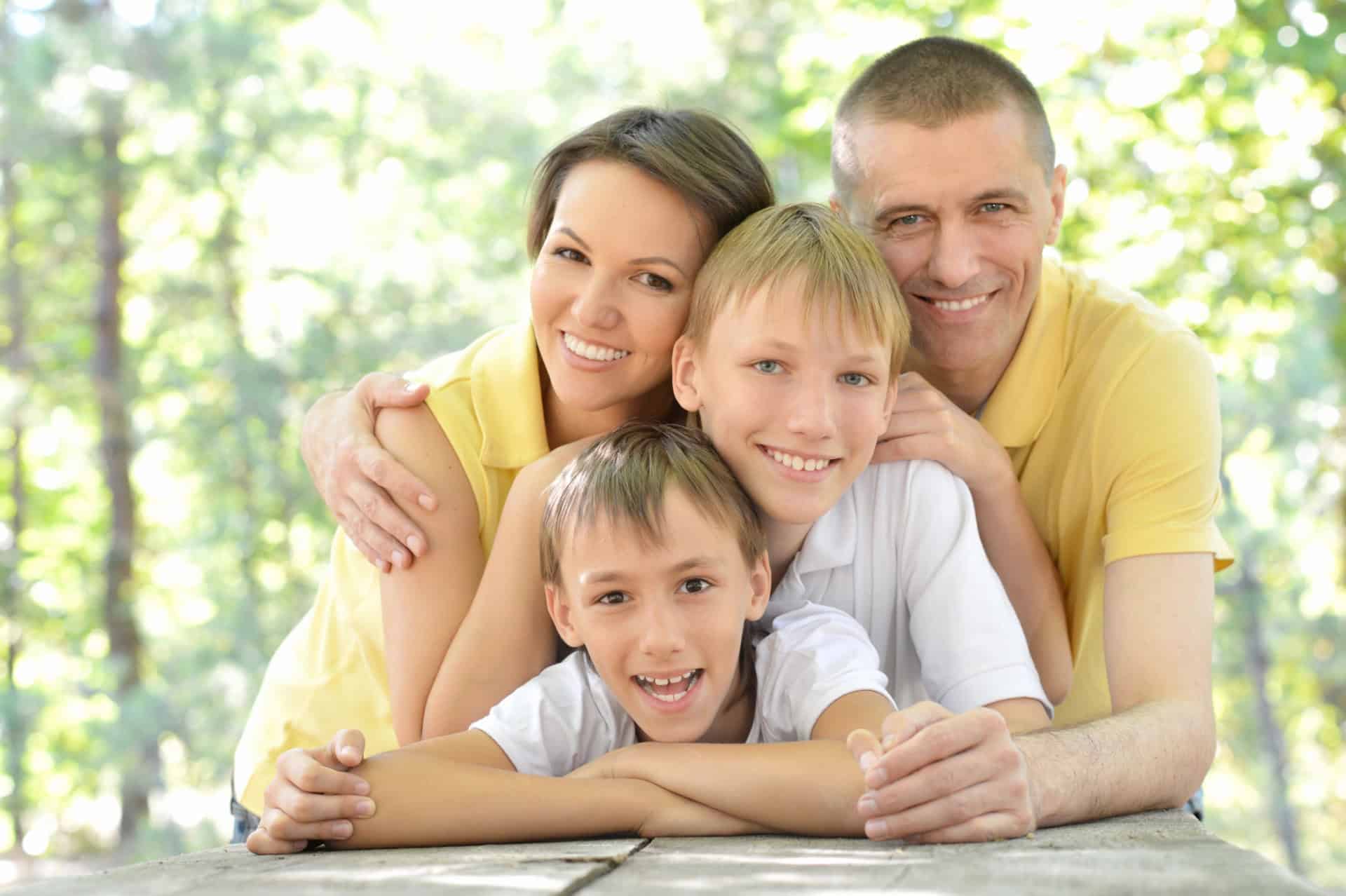 Joyful family enjoying outdoor time, symbolizing positivity and family support in education.