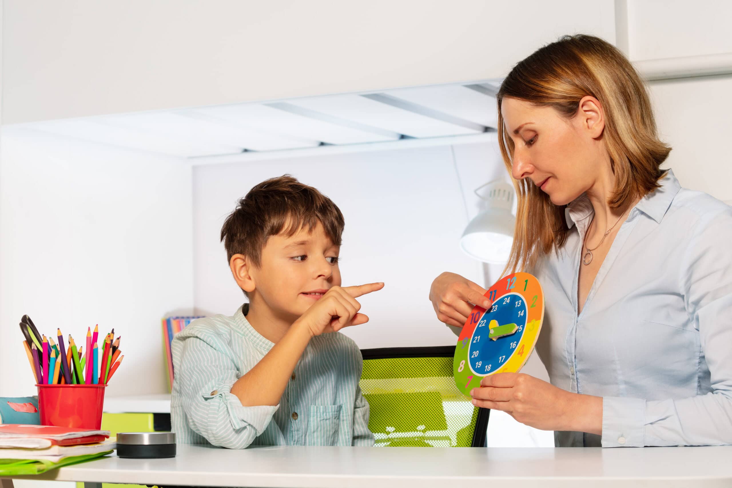 Child and teacher engaging in behavior therapy session.