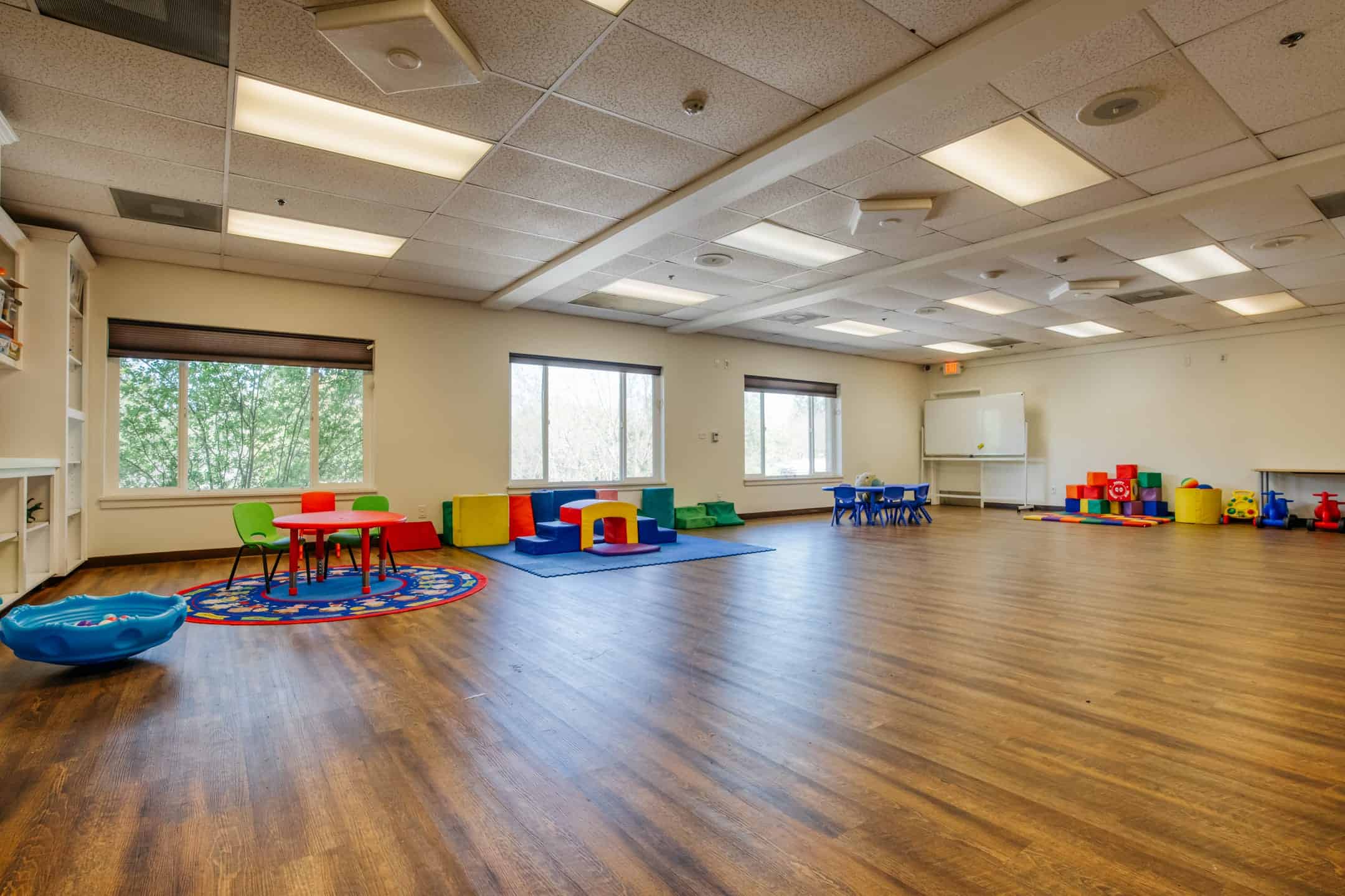 Accessible classroom with colorful furniture and play areas for young children.