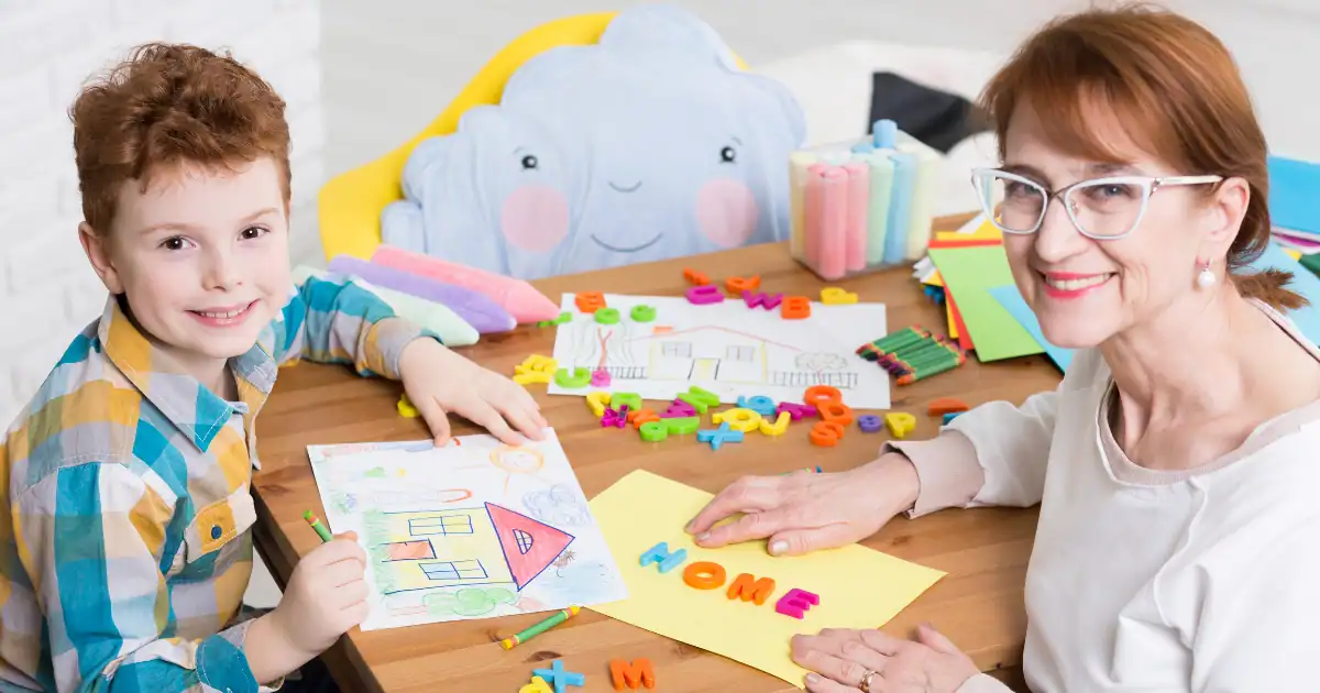 Child and therapist engaging in educational activities at a table.